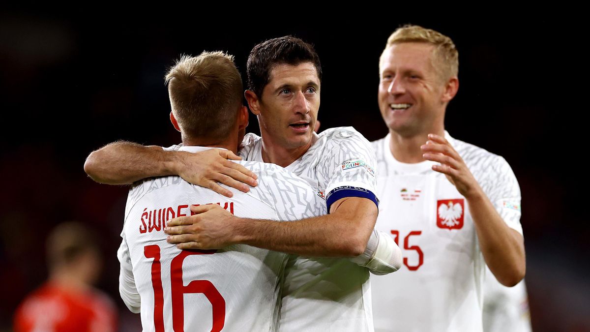 Karol Swiderski of Poland celebrates with teammate Robert Lewandowski after scoring their team's first goal during the UEFA Nations League League A Group 4 match between Wales and Poland at Cardiff City Stadium on September 25, 2022 in Cardiff, Wales.