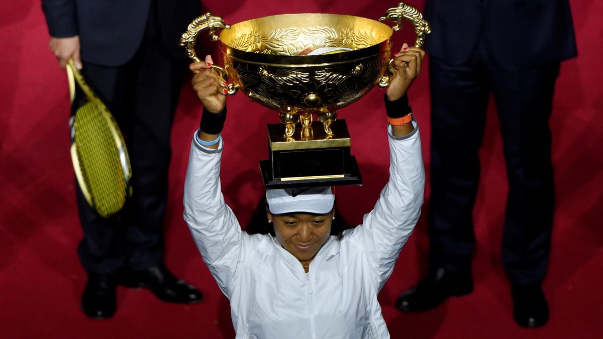 Naomi Osaka of Japan poses with the trophy after winning her women's singles final match against Ashleigh Barty of Australia at the China Open tennis tournament in Beijing on October 6, 2019