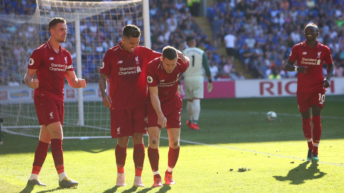 Liverpool's English midfielder James Milner (C) celebrates scoring their second goal from the penalty spot during the English Premier League football match between between Cardiff City and Liverpool at Cardiff City Stadium in Cardiff, south Wales on April