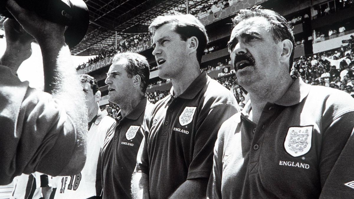 England's (L-R) Ray Clemence, coach Glenn Hoddle and John Gorman sing the National Anthem before the match.