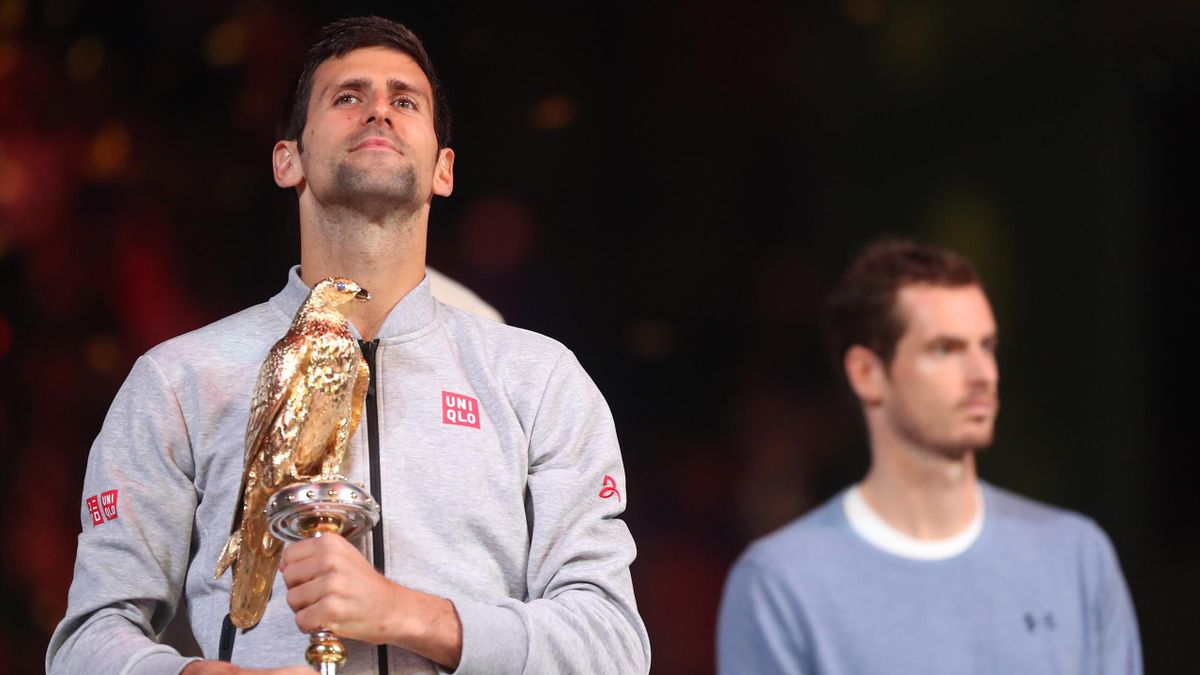 Serbia's Novak Djokovic poses with the winner's trophy after beating Britain's Andy Murray