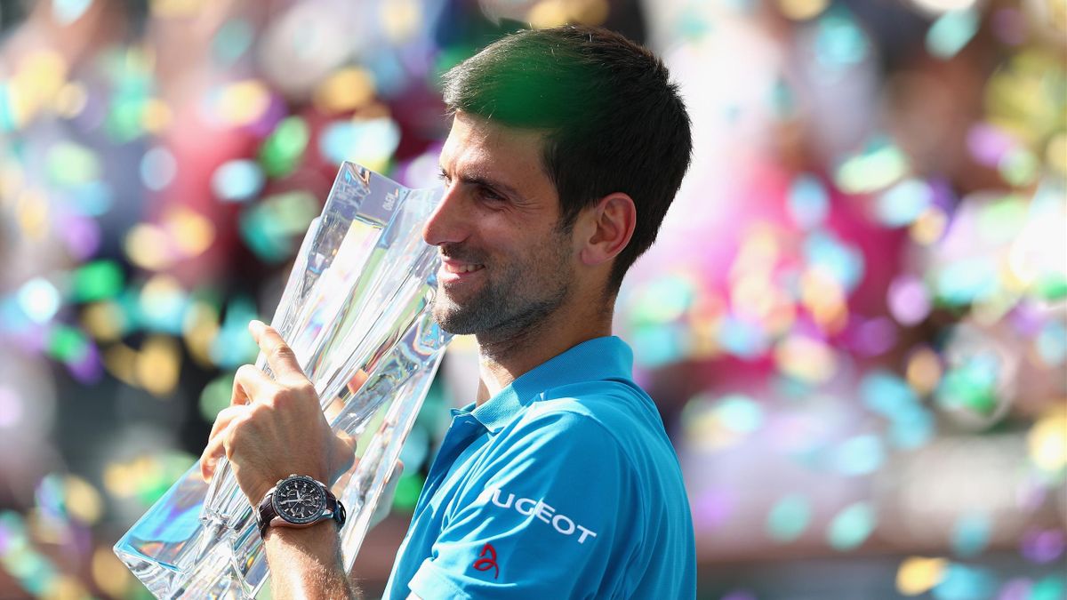 Novak Djokovic of Serbia kisses the trophy after defeating Milos Raonic of Canada in the men's final of the BNP Paribas Open at the Indian Wells Tennis Garden in Indian Wells, California, March 20, 2016. Djokovic defeated Raonic 6-2, 6-0.