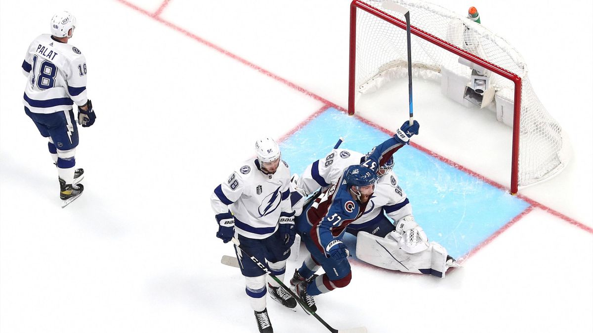 J.T. Compher #37 of the Colorado Avalanche reacts after teammate Andre Burakovsky #95 scores a goal against Andrei Vasilevskiy #88 of the Tampa Bay Lightning during overtime to win Game One of the 2022 Stanley Cup Final 4-3 at Ball Arena on June 15, 2022