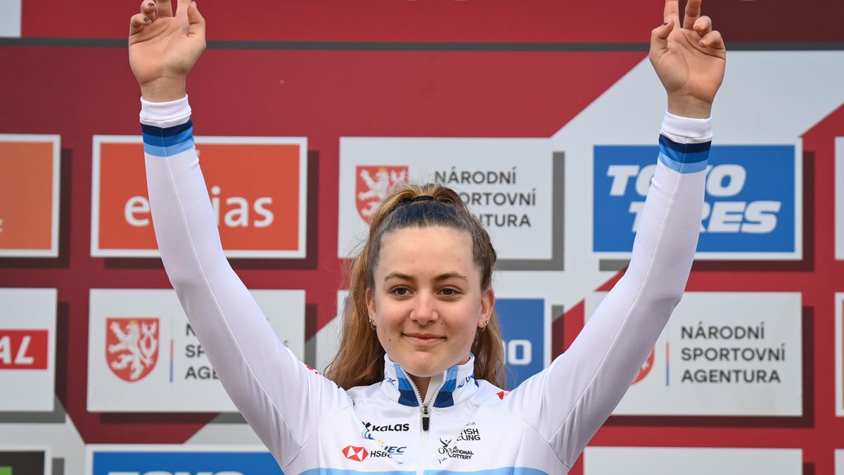 Zoe Backstedt salutes the crowd from the podium of the European Cyclo-cross Championships where she won the junior title