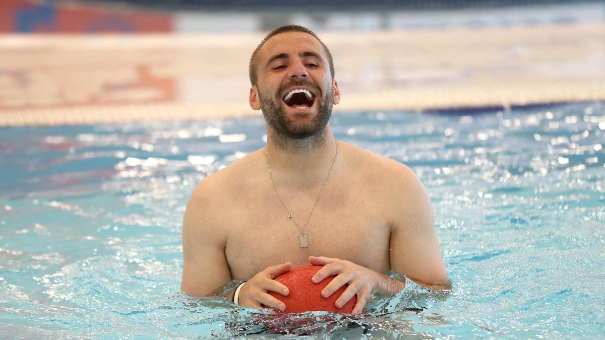 Luke Shaw of England reacts in the swimming pool at St George's Park on June 24, 2021 in Burton upon Trent, England.
