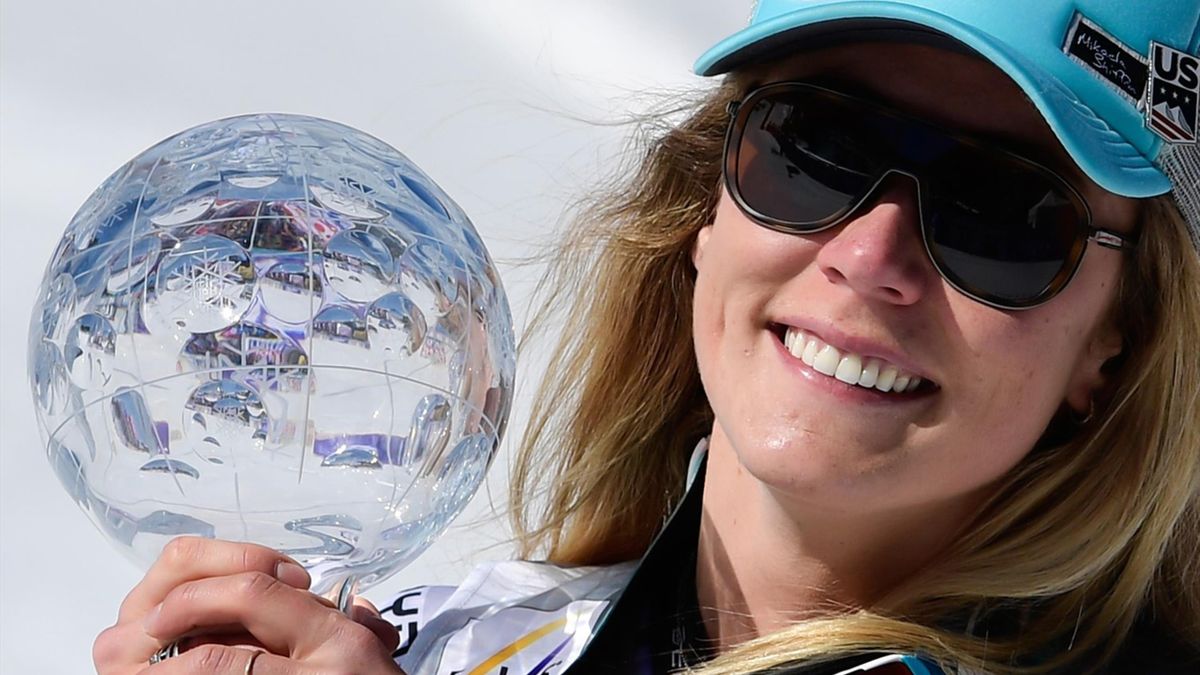 US Mikaela Shiffrin celebrates as she receives the overall FIS Alpine ski giant slalom crystal globe trophy