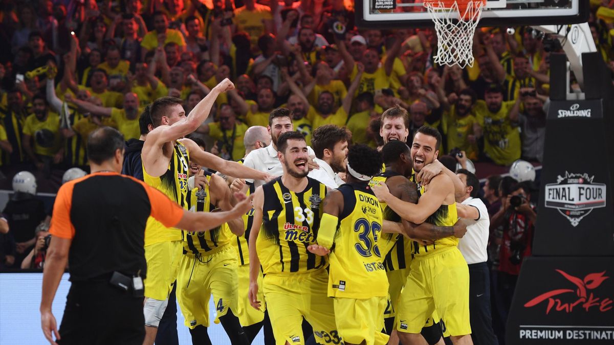 Fenerbahce's players celebrate winning the first place basketball match between Fenerbahce and Olympiacos at the Euroleague Final Four