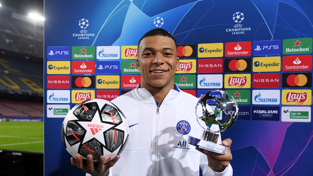 Kylian Mbappe of Paris Saint-Germain poses for a photo with the match ball and the player of the match award after the UEFA Champions League Round of 16 match between FC Barcelona and Paris Saint-Germain at Camp Nou on February 16, 2021 in Barcelona,