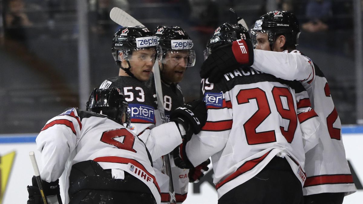 Canada's Nate Mackinnon, 2nd right, is congratulated by teammates after scoring during the Ice Hockey World Championships group B match between Belarus and Canada in the AccorHotels Arena in Paris