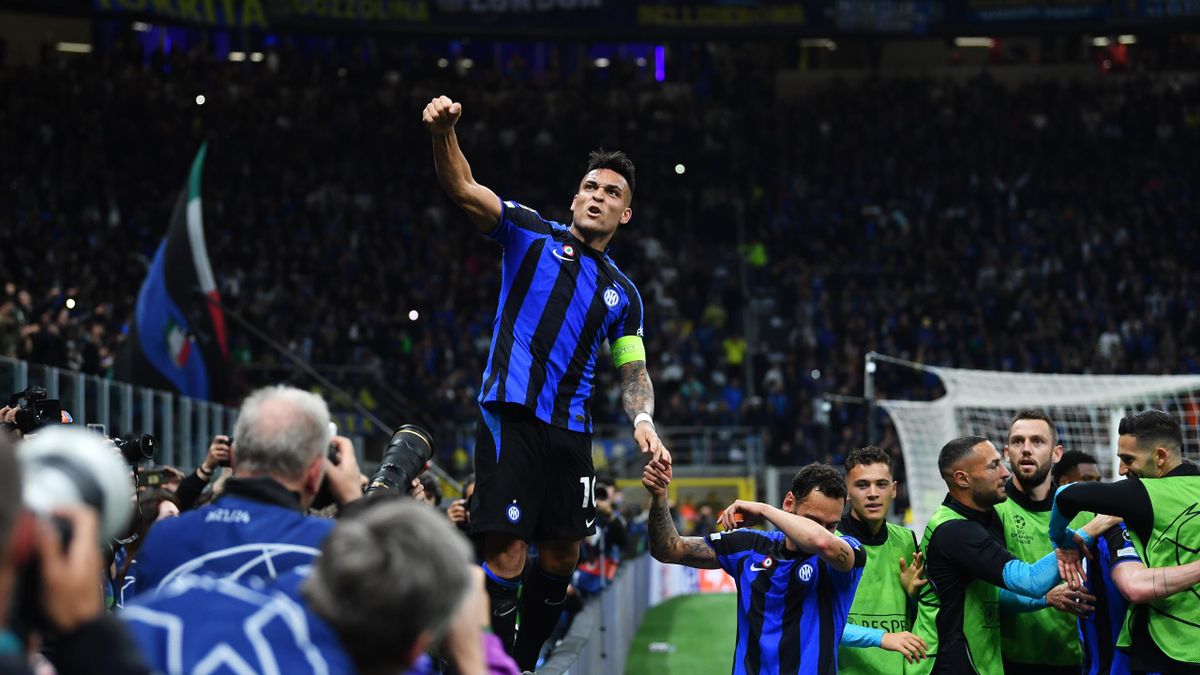 Lautaro Martinez of FC Internazionale celebrates while standing on the advertisement board after scoring the team's first goal during the UEFA Champions League semi-final second leg match between FC Internazionale and AC Milan at Stadio Giuseppe Meazza