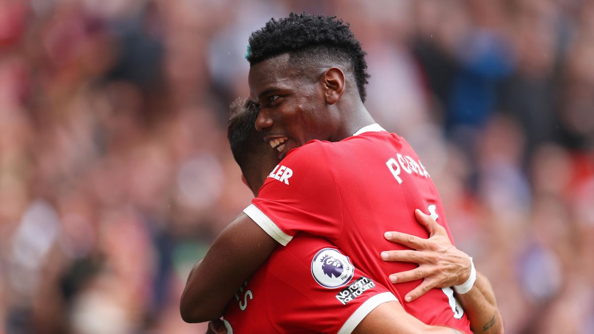 Bruno Fernandes of Manchester United celebrates after scoring a goal with Paul Pogba during the Premier League match between Manchester United and Leeds United at Old Trafford on August 14, 2021 in Manchester, England