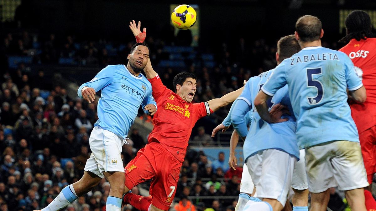MANCHESTER, ENGLAND - DECEMBER 26: (THE SUN OUT, THE SUN ON SUNDAY OUT) Luis Suarez of Liverpool is push in the box by Joleon Lescott of Manchester City during the Barclays Premier League match between Manchester United and Liverpool at Etihad Stadium on