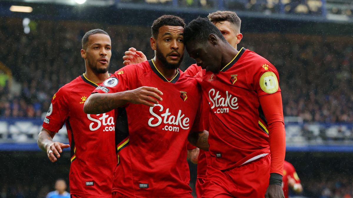 oshua King of Watford FC celebrates with Ismaila Sarr and teammates after scoring their side's first goal during the Premier League match between Everton and Watford at Goodison Park on October 23, 2021 in Liverpool, England.