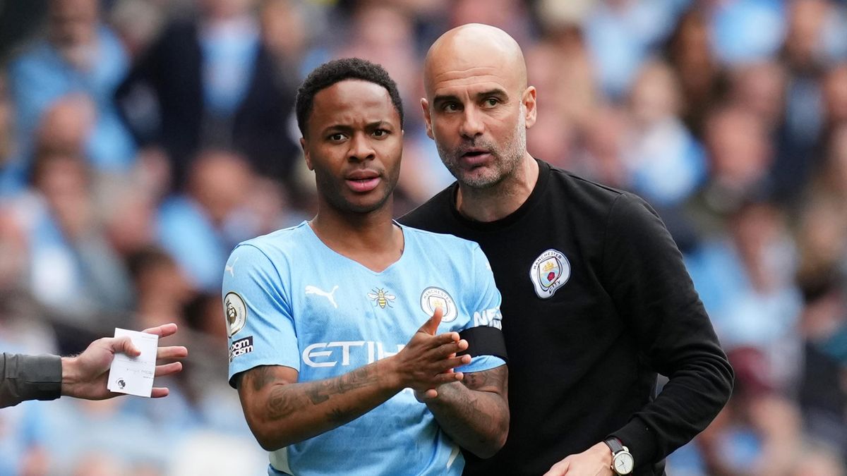 Pep Guardiola gives instructions to Raheem Sterling of Manchester City before they are substituted on during the Premier League match between Manchester City and Aston Villa at Etihad Stadium on May 22, 2022 in Manchester, England