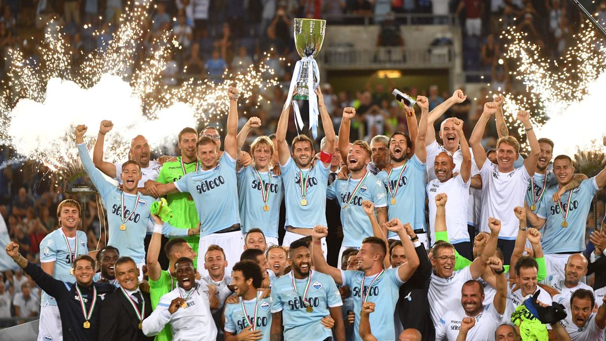 Lazio's players celebrate with the trophy after winning the Italian SuperCup TIM football match Juventus