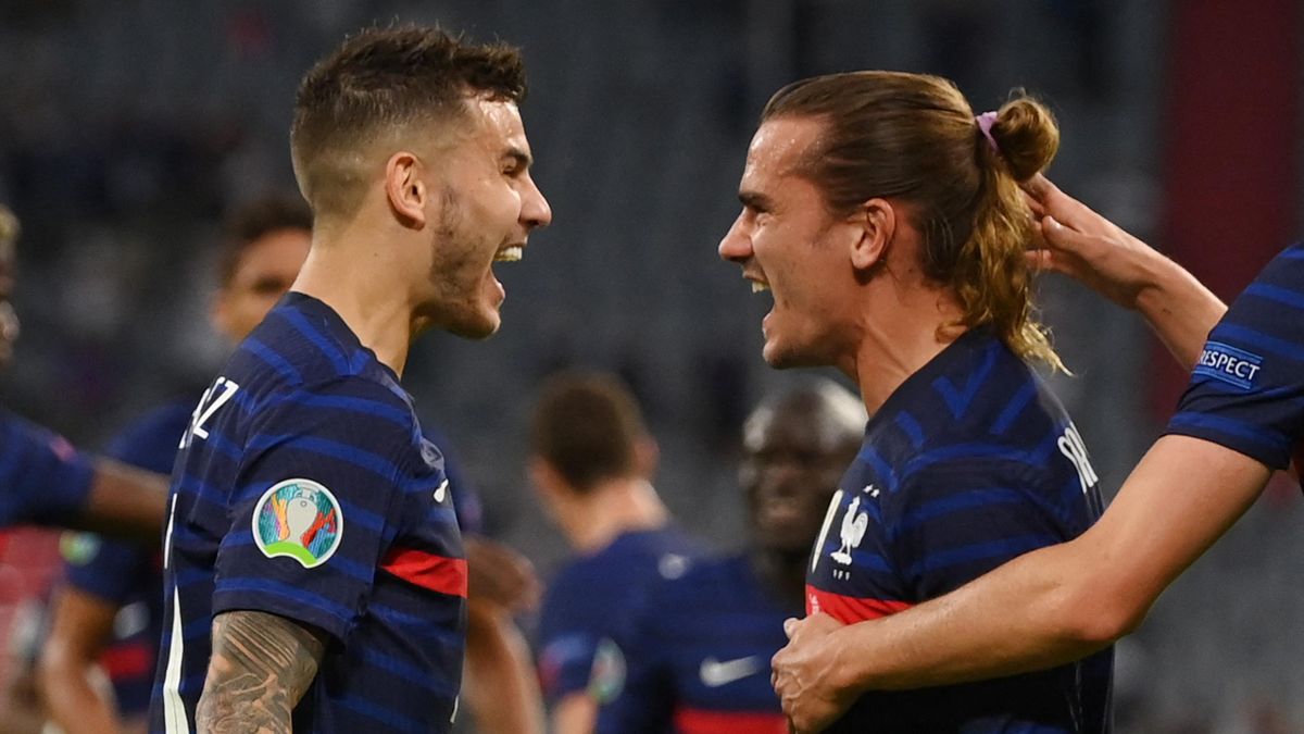 France's defender Lucas Hernandez (L) celebrates the first goal with France's forward Antoine Griezmann during the UEFA EURO 2020 Group F football match between France and Germany at the Allianz Arena in Munich on June 15, 2021.