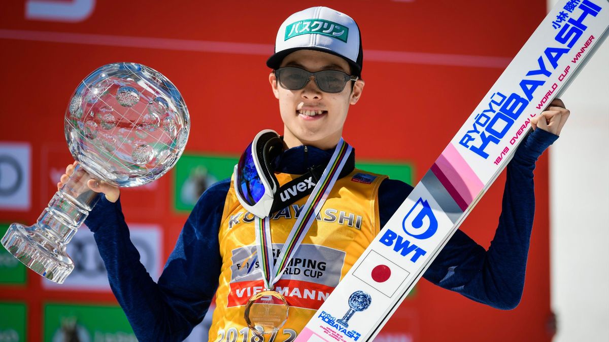 Japan's Ryoyu Kobayashi poses with the crystal globe trophy after winning the overall classification of the FIS Ski Jumping World Cup in Planica, on March 24, 2019.