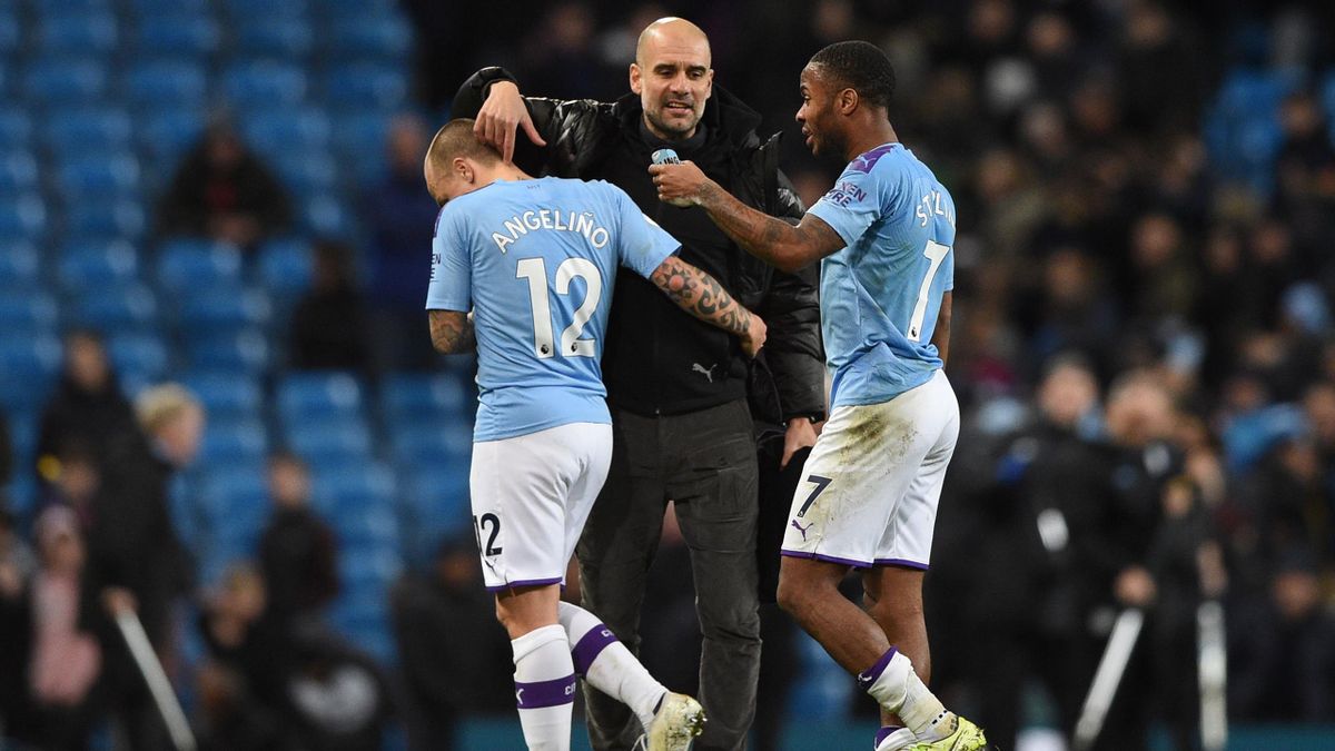 Manchester City's Spanish manager Pep Guardiola (C) greets Manchester City's Spanish defender Angelino (L) and Manchester City's English midfielder Raheem Sterling (R) at the end of the English Premier League football match between Manchester City and Man
