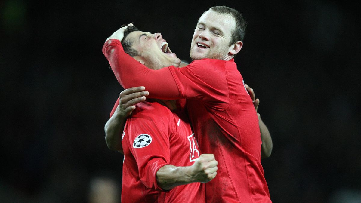 Manchester United's Portugese midfielder Cristiano Ronaldo (L) celebrates scoring against Olympique Lyonnais with team-mateWayne Rooney during their UEFA Champions League football match at Old Trafford, Manchester, north-west England on March 4, 2008
