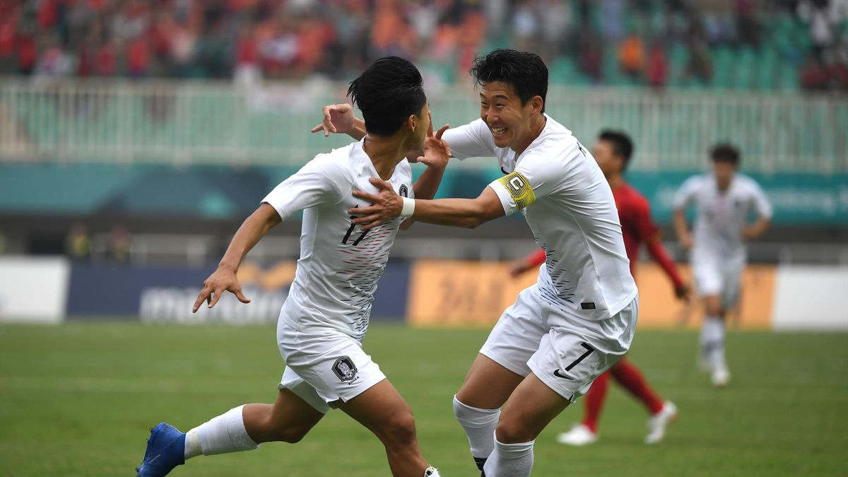 South Korea's Lee Seung-woo (L) celebrates with teammate Son Heung-min (R) after scoring during the men's football semi-final match between Vietnam and South Korea at the 2018 Asian Games in Bogor on August 29, 2018.