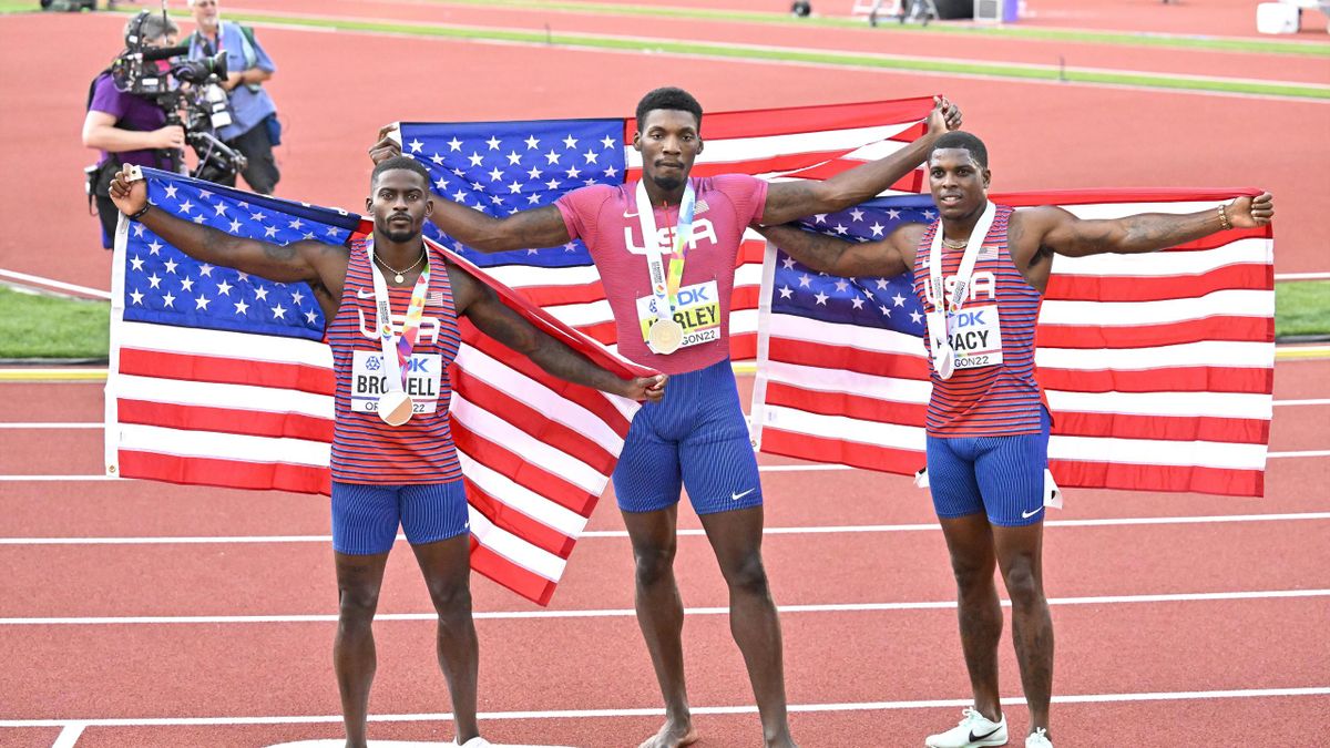Trayvon Bromell of USA, Fred Kerley of USA, Marvin Bracy of USA with flags after the Men's 100 metres during the World Athletics Championships on July 16, 2022 in Eugene, Oregon.