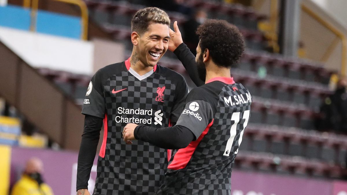 Liverpool's Brazilian midfielder Roberto Firmino (L) celebrates scoring his team's first goal with Liverpool's Egyptian midfielder Mohamed Salah during the English Premier League football match between Burnley and Liverpool at Turf Moor