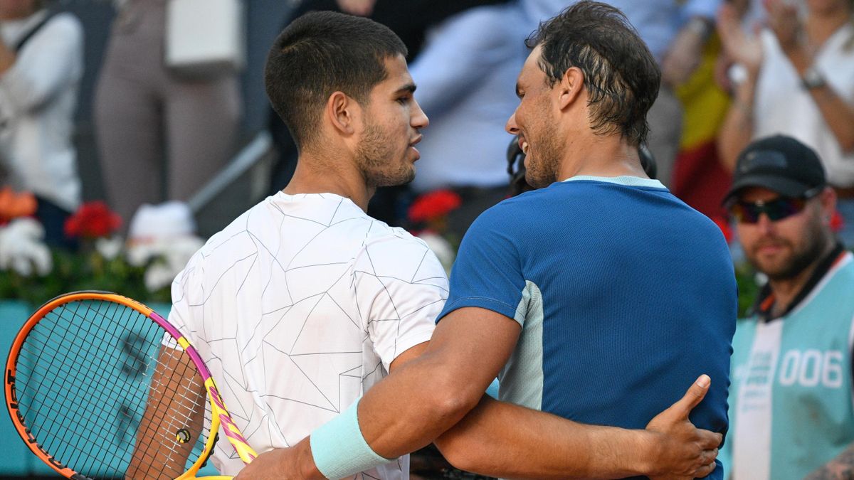 MAY 06: Carlos Alcaraz greets Rafael Nadal at the net following their match at the Mutua Madrid Open, on May 6, 2022, in Madrid, Spain.
