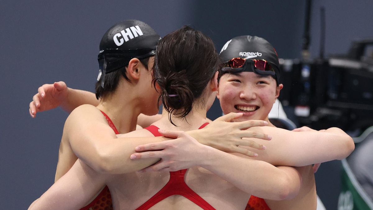 Junxuan Yang, Muhan Tang and Yufei Zhang of Team China react after winning the gold medal in the women's 4x200m freestyle relay final
