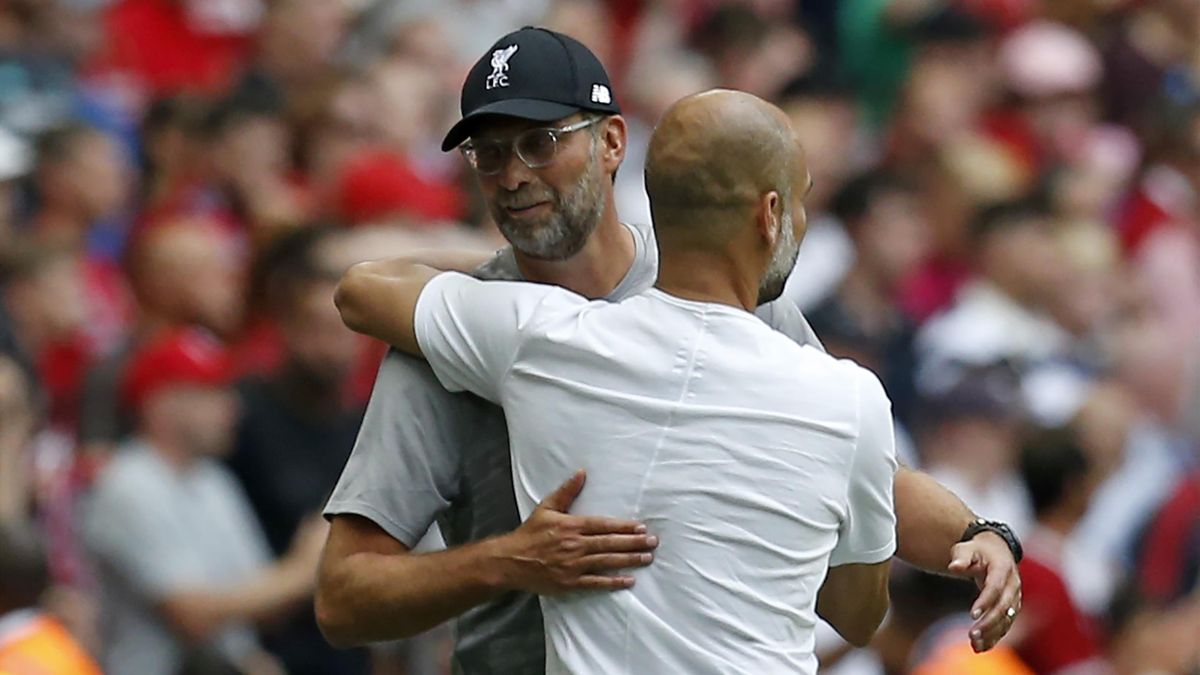 Liverpool's German manager Jurgen Klopp (L) and Manchester City's Spanish manager Pep Guardiola embrace at the final whistle in the English FA Community Shield football match between Manchester City and Liverpool at Wembley Stadium in north London on Augu