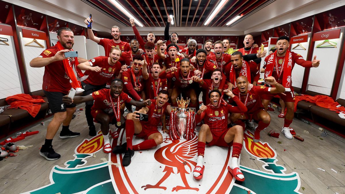 Liverpool celebrate in the dressing room with the premier league trophy after winning the Premier league at the end of the Premier League match between Liverpool FC and Chelsea FC at Anfield on July 22, 2020 in Liverpool, England.