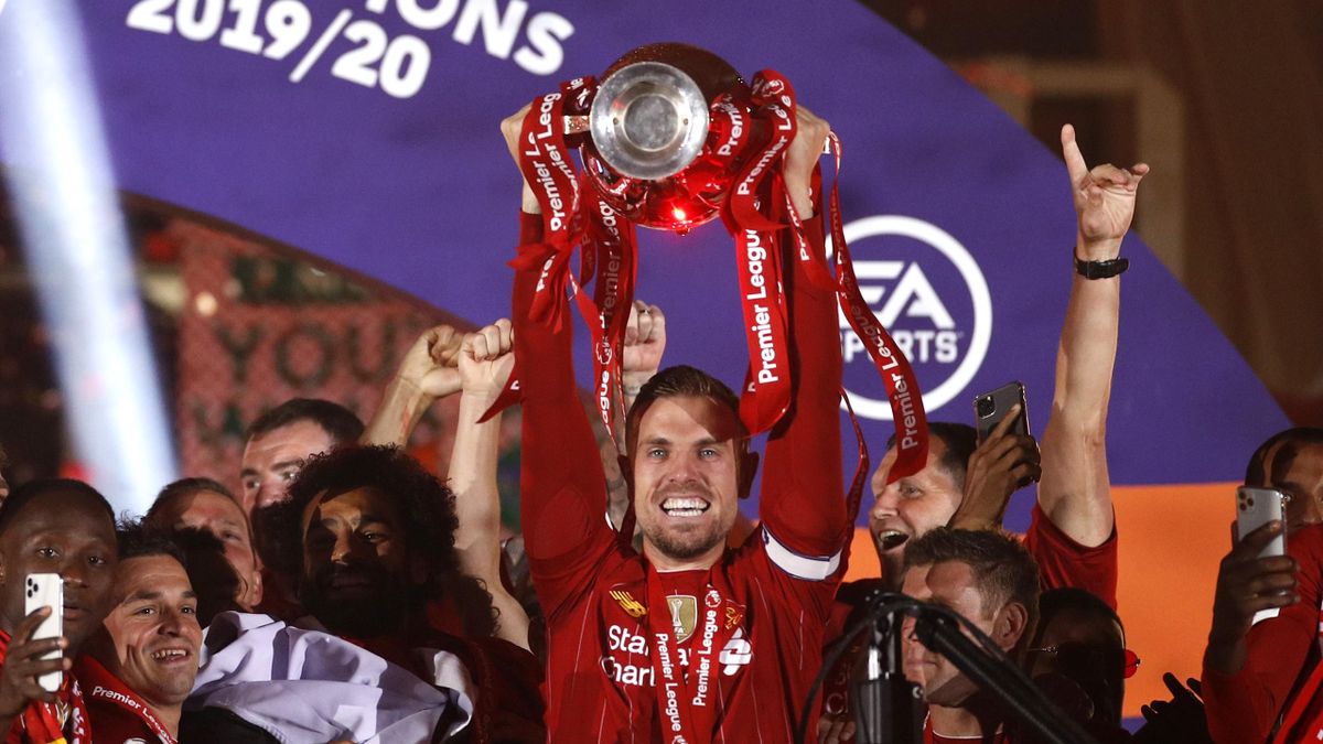 Liverpool captain Jordan Henderson lifts the Premier League trophy.
