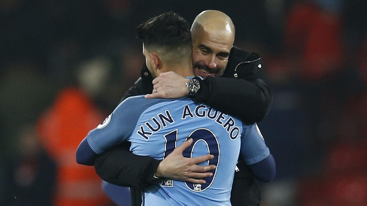 Manchester City manager Pep Guardiola celebrates with Sergio Aguero after the game