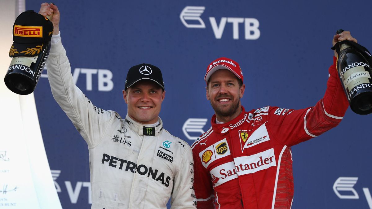 Race winner Valtteri Bottas of Finland and Mercedes GP celebrates with second placed finisher Sebastian Vettel of Germany and Ferrari on the podium during the Formula One Grand Prix of Russia on April 30, 2017 in Sochi, Russia.