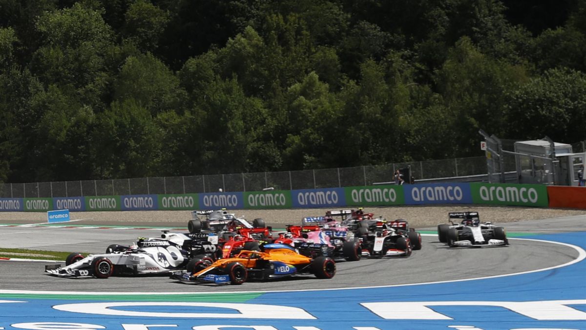 This picture taken on July 12, 2020 in Spielberg, Austria shows a collision between Ferrari's German driver Sebastian Vettel and Ferrari's Monegasque driver Charles Leclerc at the start of the Formula One Styrian Grand Prix race.