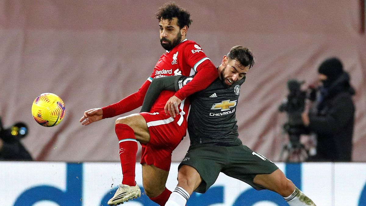Liverpool's Egyptian midfielder Mohamed Salah (L) vies with Manchester United's Portuguese midfielder Bruno Fernandes during the English Premier League football match between Liverpool and Manchester United at Anfield in Liverpool, north west England on J