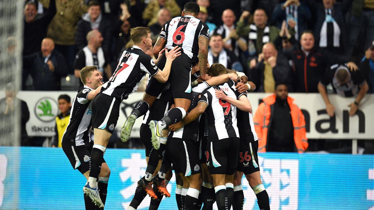 Callum Wilson is mobbed by teammates after Ben White's own goal hands Newcastle the lead over Arsenal