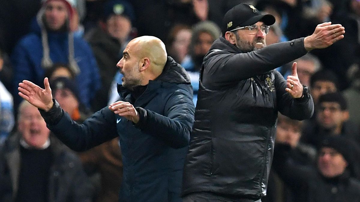 Liverpool's German manager Jurgen Klopp (R) and Manchester City's Spanish manager Pep Guardiola (L) gesture on the touchline during the English Premier League football match between Manchester City and Liverpool at the Etihad Stadium in Manchester, north