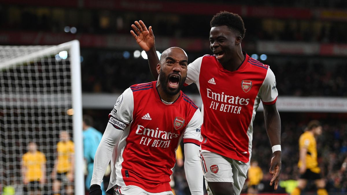 LONDON, ENGLAND - FEBRUARY 24: Alexandre Lacazette of Arsenal celebrates their sides second goal with team mate Bukayo Saka during the Premier League match between Arsenal and Wolverhampton Wanderers at Emirates Stadium on February 24, 2022 in London, Eng