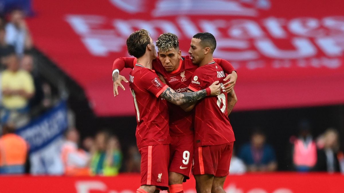 Roberto Firmino of Liverpool celebrates with teammates scoring their team's third penalty in the penalty shoot out during The FA Cup Final match between Chelsea and Liverpool at Wembley Stadium on May 14, 2022 in London, England