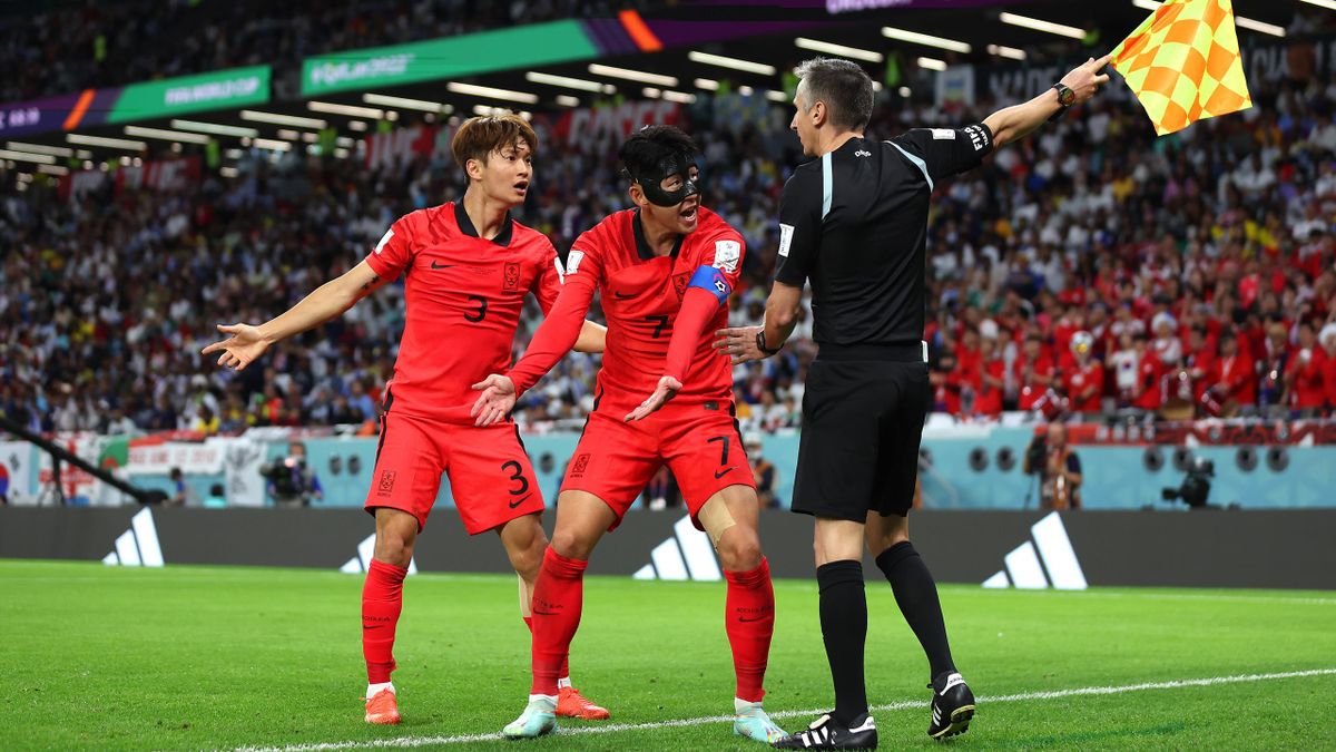Heungmin Son (C) and Jinsu Kim of Korea Republic argue a call with match officials during the FIFA World Cup Qatar 2022 Group H match between Uruguay and Korea Republic at Education City Stadium