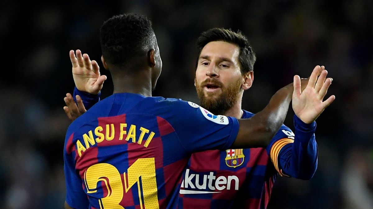 Barcelona's Guinea-Bissau forward Ansu Fati (L) celebrates with Barcelona's Argentine forward Lionel Messi after scoring during the Spanish league football match be tween FC Barcelona and Levante UD at the Camp Nou stadium in Barcelona, on February 2, 202