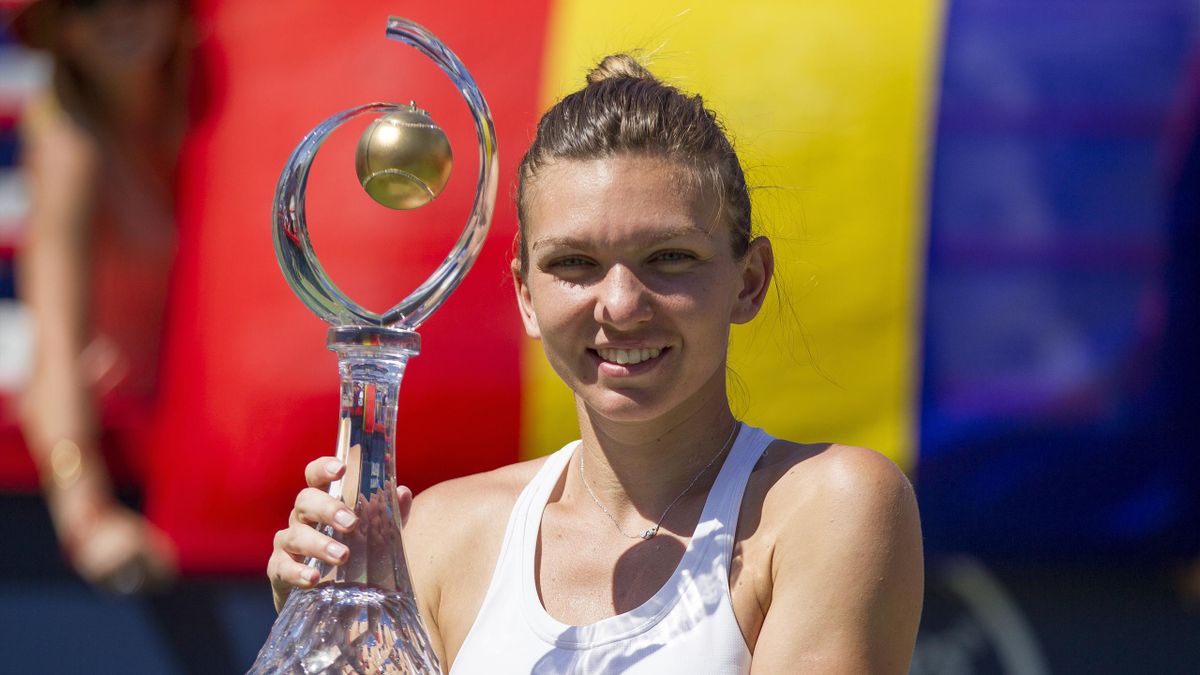 Simona Halep of Romania hoists the Rogers Cup after defeating Madison Keys of the United States in the final at Uniprix Stadium in Montreal, Quebec, July 31, 2016