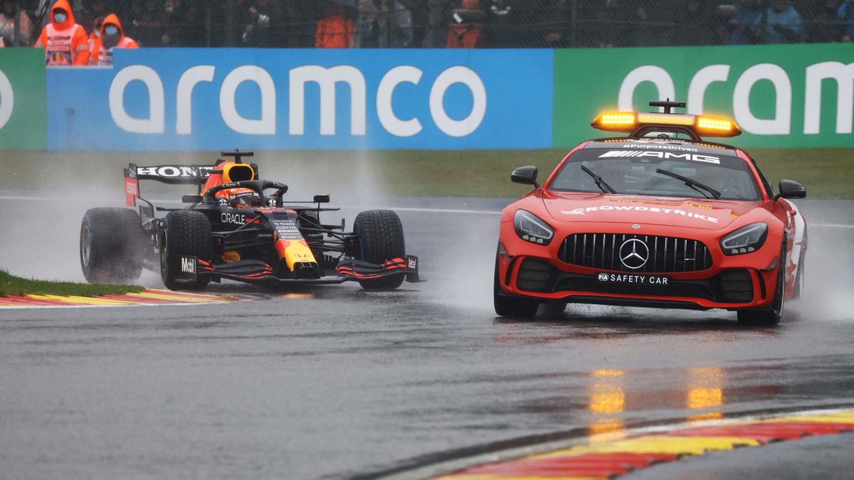 Red Bull's Dutch driver Max Verstappen (L) drives behind the safety car during formation laps in rainy weather as the start of the race in postponed before the Formula One Belgian Grand Prix at the Spa-Francorchamps circuit in Spa on August 29, 2021