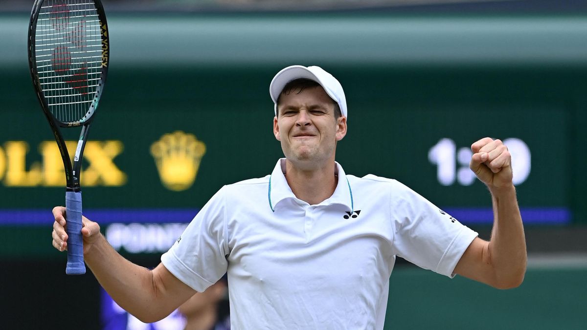 Poland's Hubert Hurkacz celebrates winning against Switzerland's Roger Federer during their men's quarter-finals match on the ninth day of the 2021 Wimbledon Championships at The All England Tennis Club