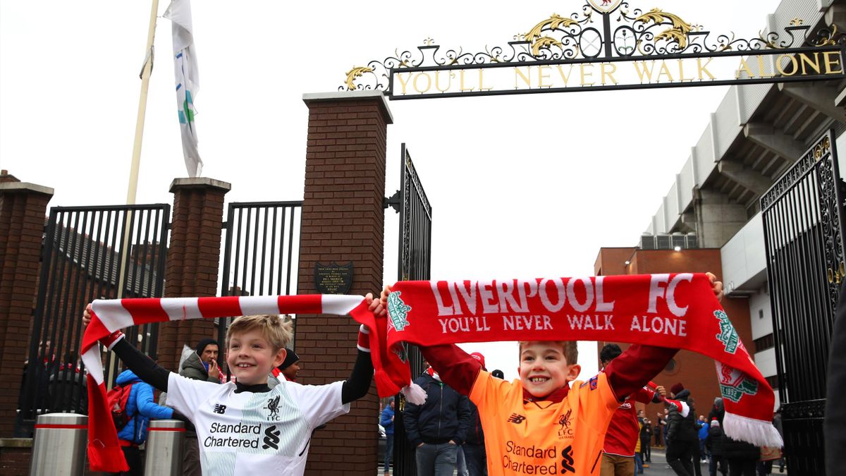 Liverpool fans pose outside the stadium prior to the Premier League match between Liverpool and Leicester City
