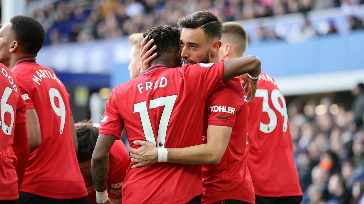 Bruno Fernandes of Manchester United celebrates with teammate Fred after scoring his team's first goal during the Premier League match between Everton FC and Manchester United