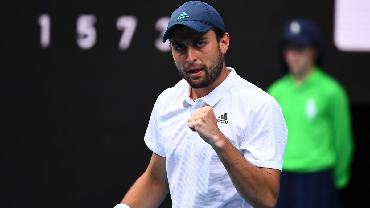 Russia's Aslan Karatsev celebrates his match point against Bulgaria's Grigor Dimitrov during their men's singles quarter-final match on day nine of the Australian Open tennis tournament in Melbourne