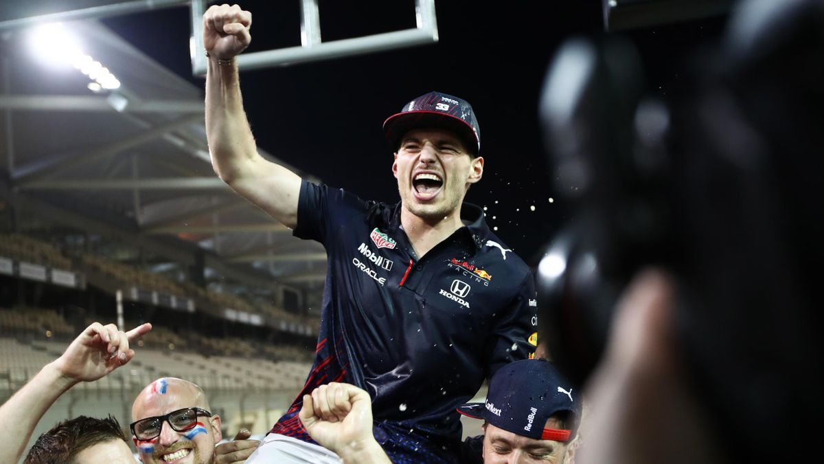 Race winner and 2021 F1 World Drivers Champion Max Verstappen of Netherlands and Red Bull Racing celebrates with his team after the F1 Grand Prix of Abu Dhabi at Yas Marina Circuit on December 12, 2021 in Abu Dhabi, United Arab Emirates.