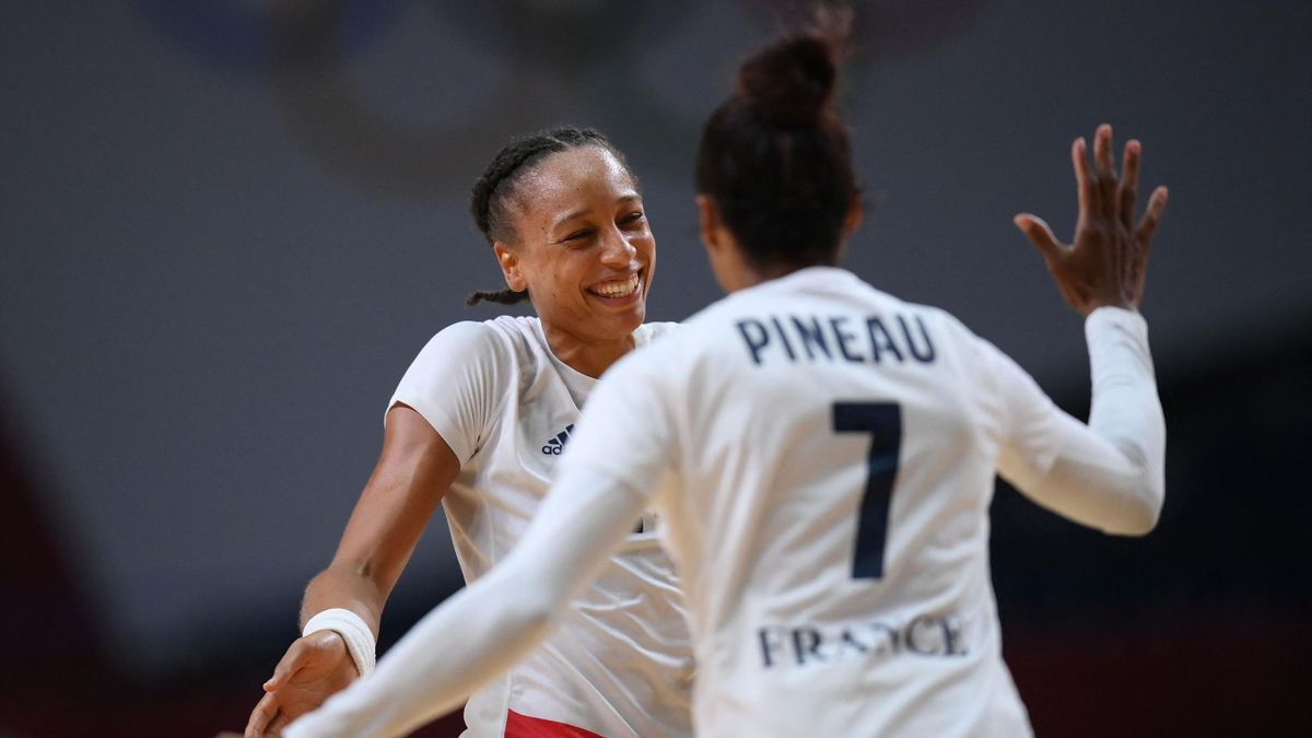France's pivot Beatrice Edwige (L) celebrates scoring a goal with France's left wing Allison Pineau during the women's preliminary round group B handball match between France and Brazil of the Tokyo 2020 Olympic Games at the Yoyogi National Stadium in Tok