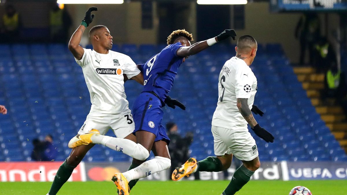 Kaio of FC Krasnodar tackles Tammy Abraham of Chelsea FC awarding Chelsea a penalty during the UEFA Champions League Group E stage match between Chelsea FC and FC Krasnodar at Stamford Bridge on December 08, 2020 in London, England